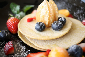 Organic pancake topping with honey, berry and fruit healthy food.