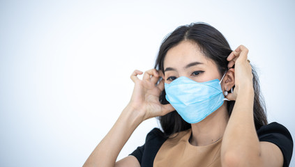 Woman wearing a hygiene protective mask to protect COVID19 virus and pm2.5 pollution while traveling in the crowded place. Woman use face mask to protect corona virus crisis in Asian country. Sickness