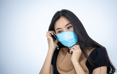 Woman wearing a hygiene protective mask to protect COVID19 virus and pm2.5 pollution while traveling in the crowded place. Woman use face mask to protect corona virus crisis in Asian country. Sickness