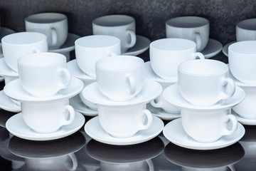 Lots of white coffee cups