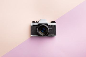 Vintage camera on color background. Retro style toned picture. Minimalistic concept
