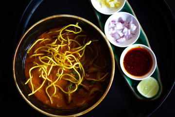 Asian food  noodles  soup  in  bowl on the wooden table vegetable and ingredient,  ramen  healthy  meal lunch traditional, closeup Hand Holding yellow noodles  spoon, delicious cooking  broth hot