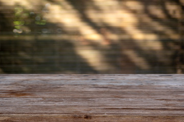 Fototapeta premium Empty wooden table with blurred background light