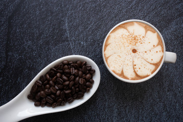 bean with coffee cup on black  background top view,