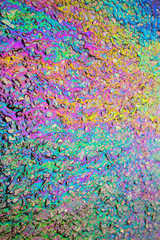 Obraz na płótnie Canvas Petrol Gasoline Oil Spill on The Road Tarmac Rainbow Colour Pollution