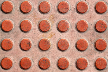 Tactile paving texture. Truncated domes top view. Detectable warnings. Close-up of walking surface...