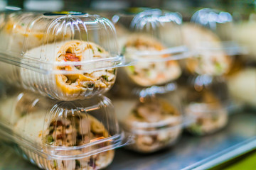 Pre-packaged sandwiches displayed in a commercial refrigerator