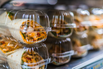 Pre-packaged sandwiches displayed in a commercial refrigerator