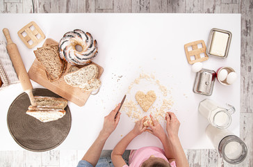 The view from the top. Mom and daughter prepare pastries in the kitchen.