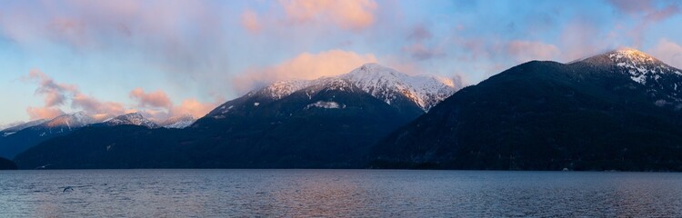 Porteau Cove, Howe Sound, near Squamish and Vancouver, British Columbia, Canada. Beautiful Panoramic Mountain Landscape View of a colorful morning sunrise in winter. Nature Background Panorama