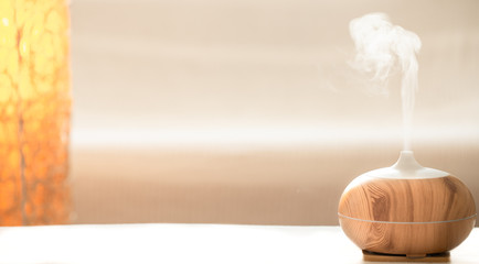 Modern oil aroma diffuser in the living room on the table.