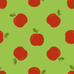 Seamless pattern with red apples on green background. Vector illustration.