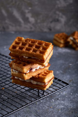delicious homemade Vienna waffles served on a gray table Vertical