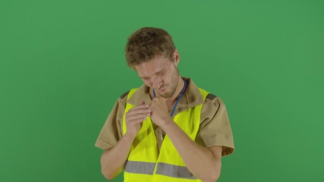 Proud Adult Man Police Officer Rubbing And Kissing His Knuckles Showing Them To The Camera Studio Isolated Shot Against Green Screen Background