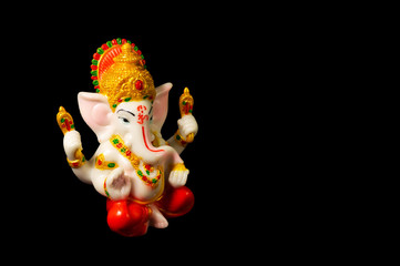 The statue of Lord Ganesha with the correct composition on the black background