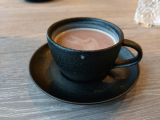 tasse de chocolat chaud en gros plan sur une table en bois dans un endroit chaleureux 