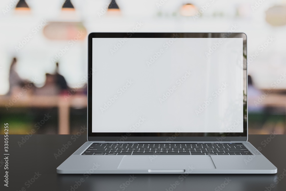 Poster laptop blank white screen placed on table in co-working space with defocused customer at cafe coffee