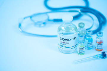 Vaccine bottles, syringe and stethoscope on white background.Vaccination against coronavirus quarantine or covid-19.Protection against virus and infection control.Medication treatment concept.