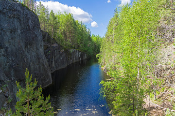 Fototapeta na wymiar Forest lake in a rocky canyon.