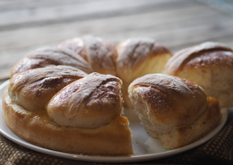 Festive Easter, Christmas or everyday bread rolls on a wooden rustic ancient table.Homemade cake. Side view.