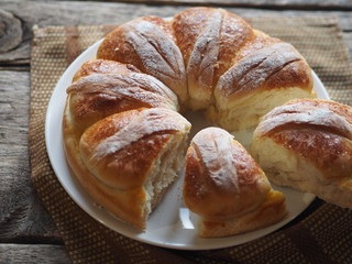 Festive Easter, Christmas or everyday bread rolls on a wooden rustic ancient table.Homemade cake. Side view.