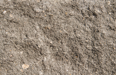 Grey concrete background. Cracked stone wall background. Grey relief concrete
