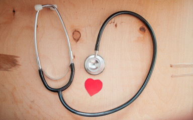 Stethoscope and red paper heart. Healthcare and medicine. Family doctor. World Health Day. World Heart Day. Heart donation. Conception medical insurance.	
