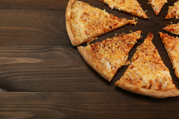 cheese pizza on dark wooden background