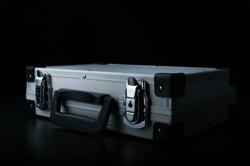 aluminum suitcase on a black background. stylish aluminum case on a dark background with copy space