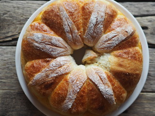 Festive Easter, Christmas or everyday bread rolls on a wooden rustic ancient table.Homemade cake. The view from the top.