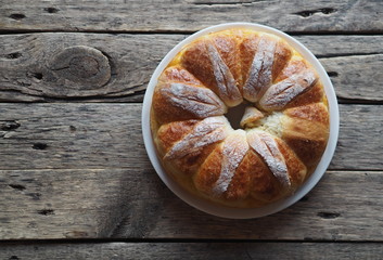 Festive Easter, Christmas or everyday bread rolls on a wooden rustic ancient table.Homemade cake. The view from the top.