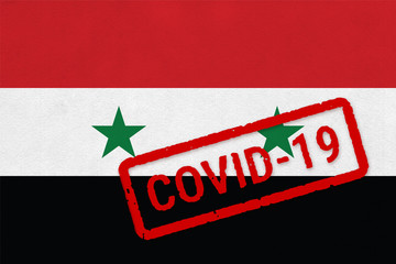 Flag of Syria on paper texture with stamp, banner of Coronavirus name on it. 2019 - 2020 Novel Coronavirus (2019-nCoV) concept, for an outbreak occurs in the Syria.