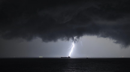 Naklejka na ściany i meble Thunderstorm at sea Singapore dangerous lightning