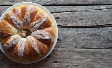 Festive Easter, Christmas or everyday bread rolls on a wooden rustic ancient table.Homemade cake. The view from the top.