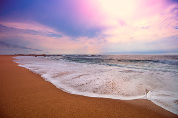 Seascape in the evening. Deserted beach. Sandy seashore with beautiful sky