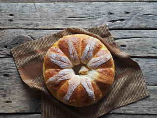 Festive Easter, Christmas or everyday bread rolls on a wooden rustic ancient table.Homemade cake. The view from the top.