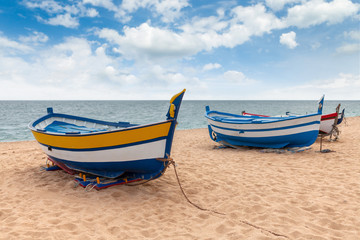Fototapeta na wymiar several colorful fishing boats by the sea on a sunny day