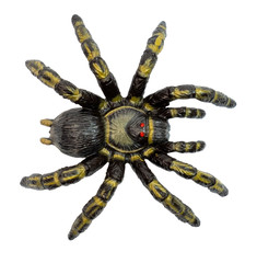 Fake tarantula like toy spider with scary red eyes. Isolated.