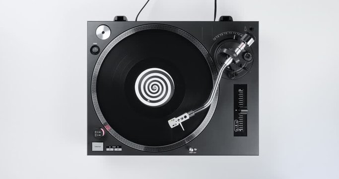 Rotating black vinyl record turntable top view musical DJ record player on stylus needle white wooden background. Loop. Macro Top view. Popular styles of disco from 90s, 70s, 80s. Party