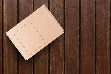 Fototapeta premium Cardboard box on a wooden background