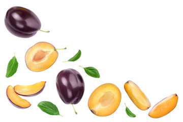 fresh purple plum and half with leaves isolated on white background with clipping path and copy spase for your text. Top view. Flat lay