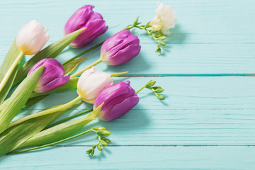 spring flowers on blue mint wooden background