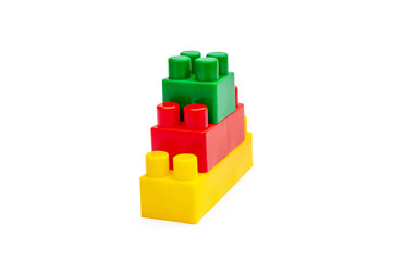 Pyramid of colored toy bricks on white.