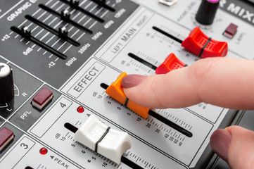 Sound engineer working on audio mixer. Close up.