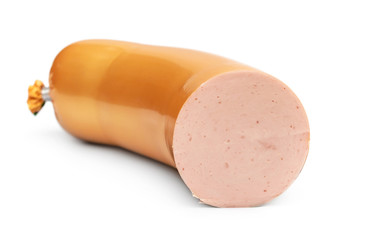 Piece of boiled sausage on a white.