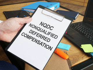 Writing note shows the text nonqualified deferred compensation NQDC