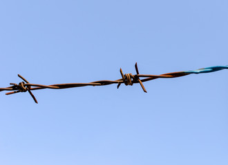 barbed wire on blue sky background