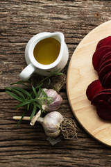 Beetroot Chips. The process of making snacks. Handmade healthy vegetable chips. On a cutting board are slices of root vegetables. Garlic and oregano spices for the dish. Soft focus