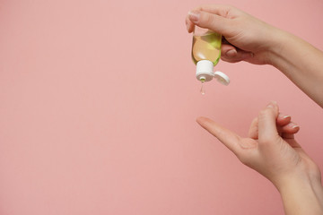 Female hands squeezing antibacterial gel. Antiseptic hand gel for hands disinfection and cleaning during flu virus outbreak, coronavirus epidemic and infectious diseases 