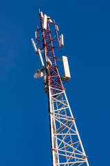 Mobile telecommunications tower or cell tower with blue sky